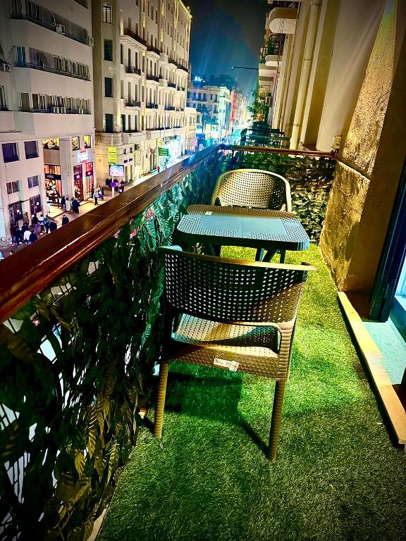 two chairs and a table on a balcony of a building at Heritage Hostel Cairo in Cairo