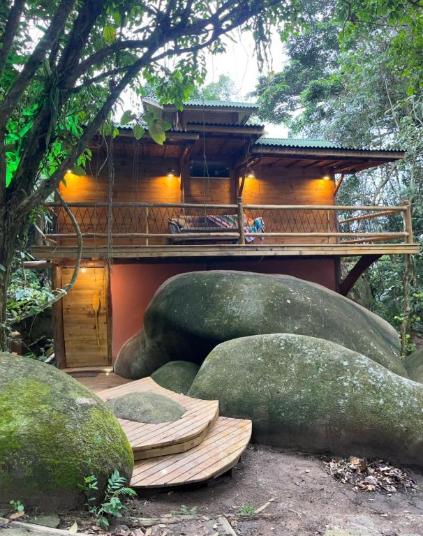 a building with large rocks in front of it at Chalé Shangri-la in Paraty