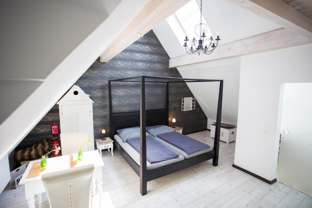 a bedroom with a black bed in a attic at Altstadtloft am Kaulberg in Bamberg