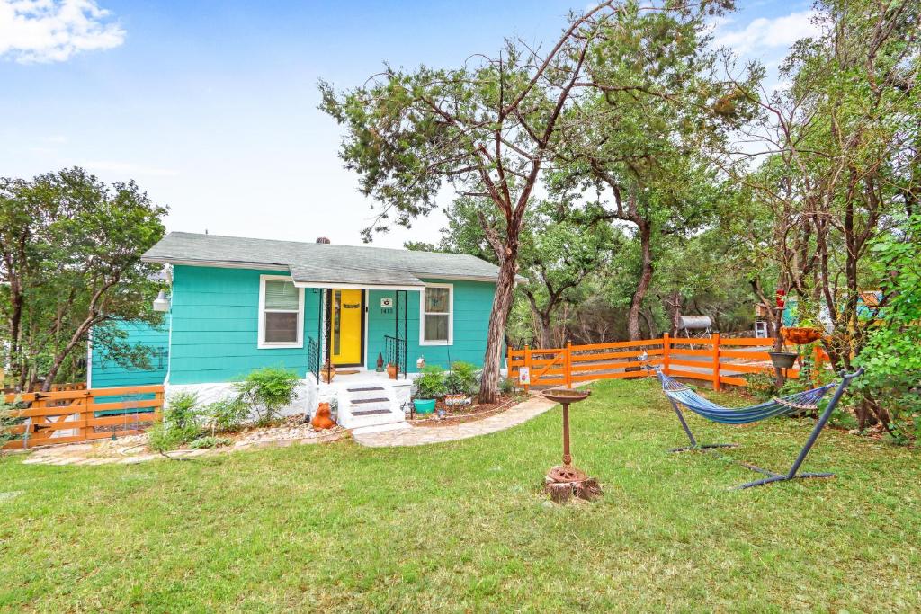 a blue house with a hammock in the yard at Coop at Canyon Lake in Canyon Lake