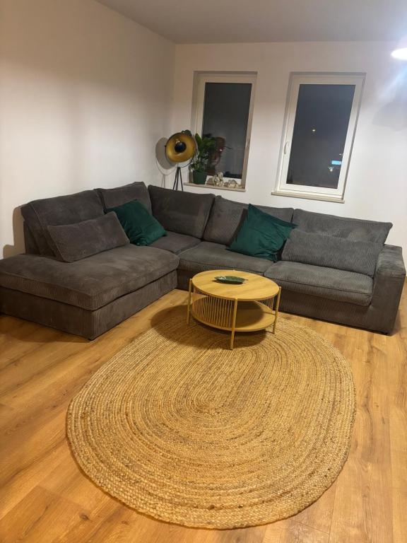 a living room with a couch and a coffee table at Apartament Przy Parku in Bełchatów