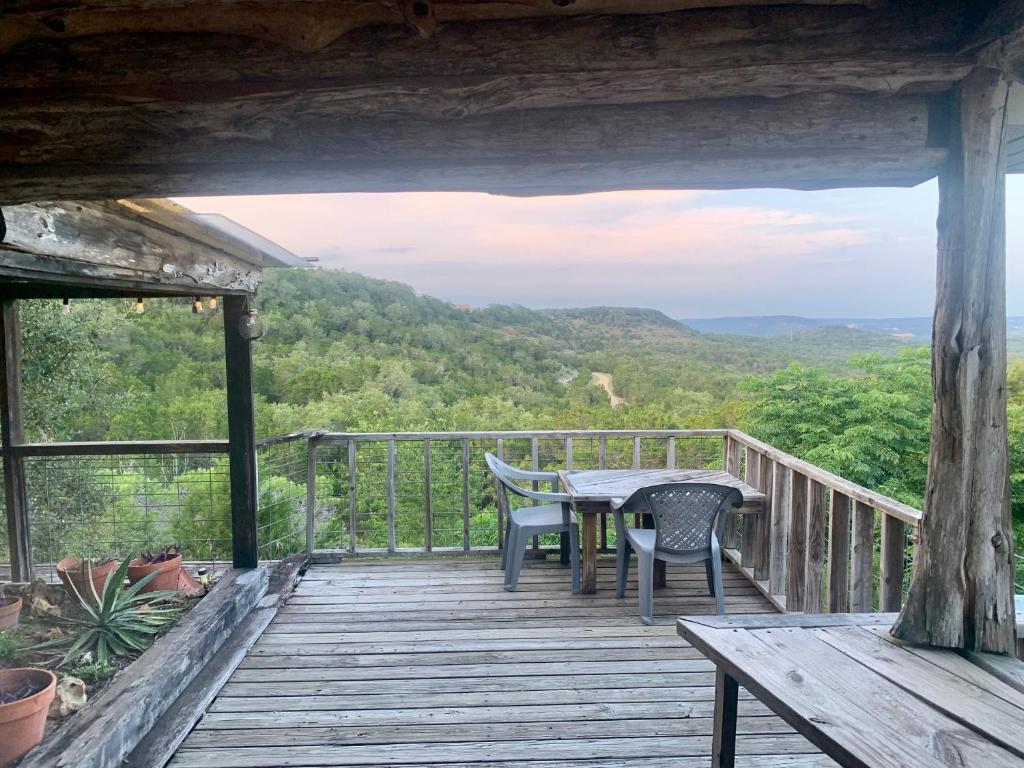 a wooden deck with a table and chairs on it at La Vista in Canyon Lake