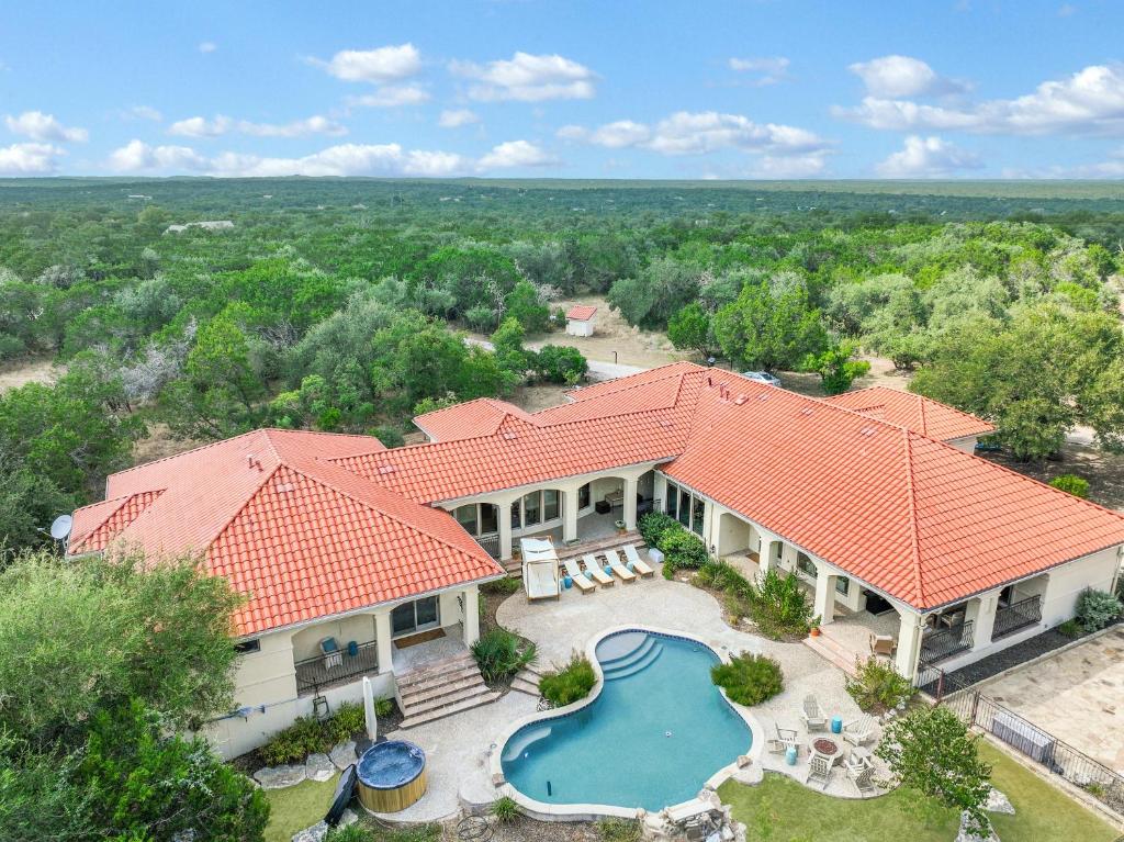 an aerial view of a house with a swimming pool at Narwhal Ranch in Wimberley