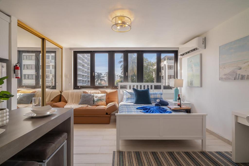 a living room with a couch and a table at Luxe Beachside Oasis Pool Parking by PH in San Juan