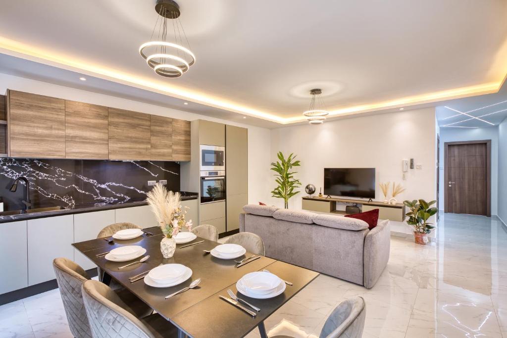a living room with a table and a couch at The Bellview Suite - Luxury 1 BR APT - Central Gzira in Il-Gżira