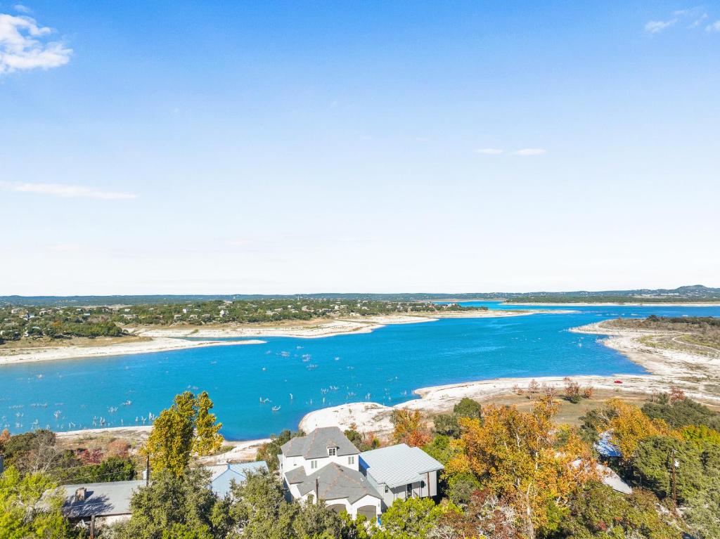 an aerial view of a house next to a body of water at Lakeside Dreamhouse in Canyon Lake