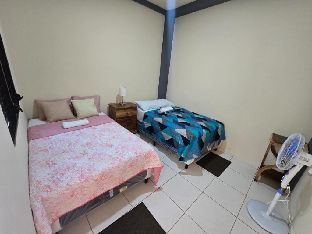 a room with two beds and a chair in it at The Stone Way Suite in Juayúa