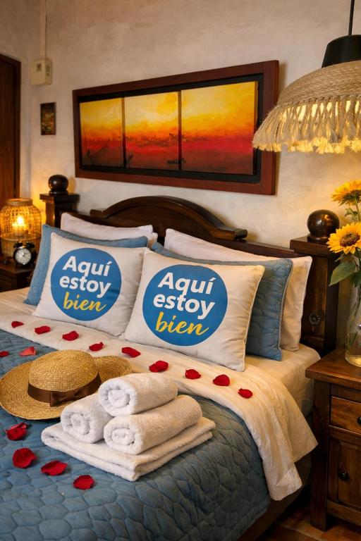 a bedroom with a bed with towels on it at AQUI ESTOY BIEN in Barichara