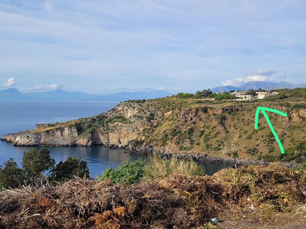 a green arrow on an island in the ocean at Casa Blu Mare privat beach 9 person in San Nicola Arcella