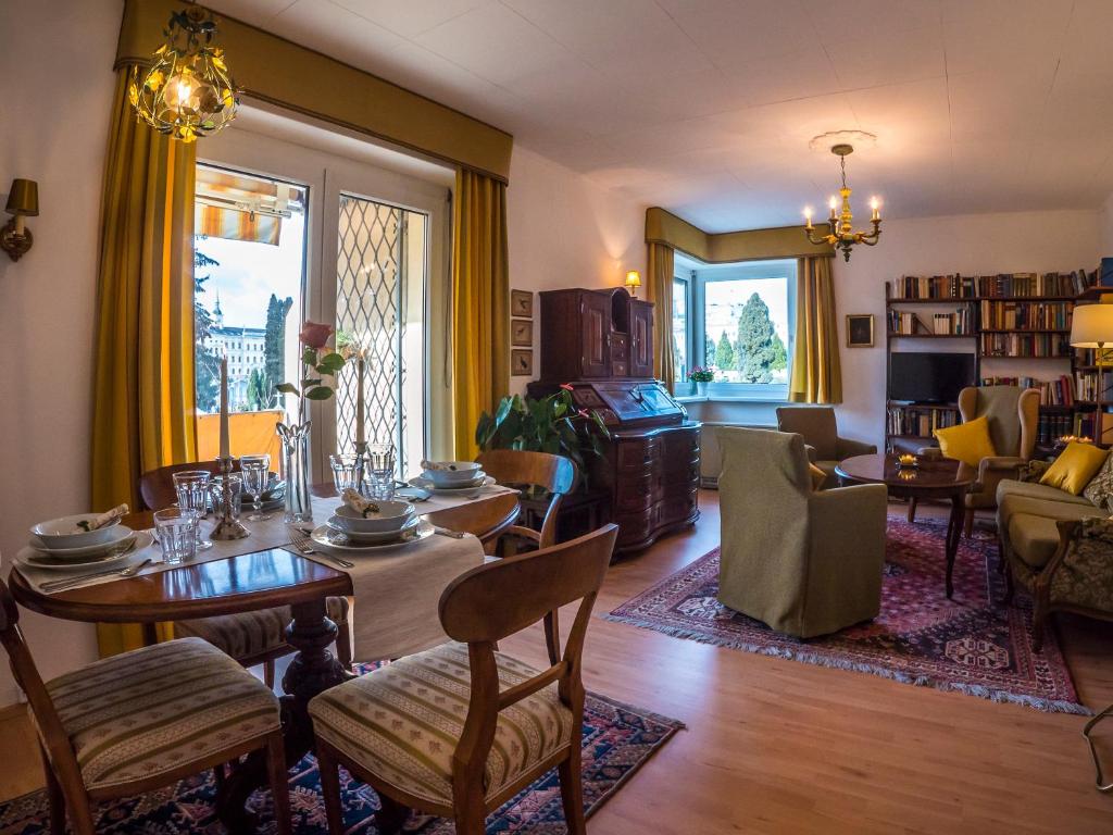 a living room with a table and chairs and a dining room at Apartment "Maria Theresia" in Graz