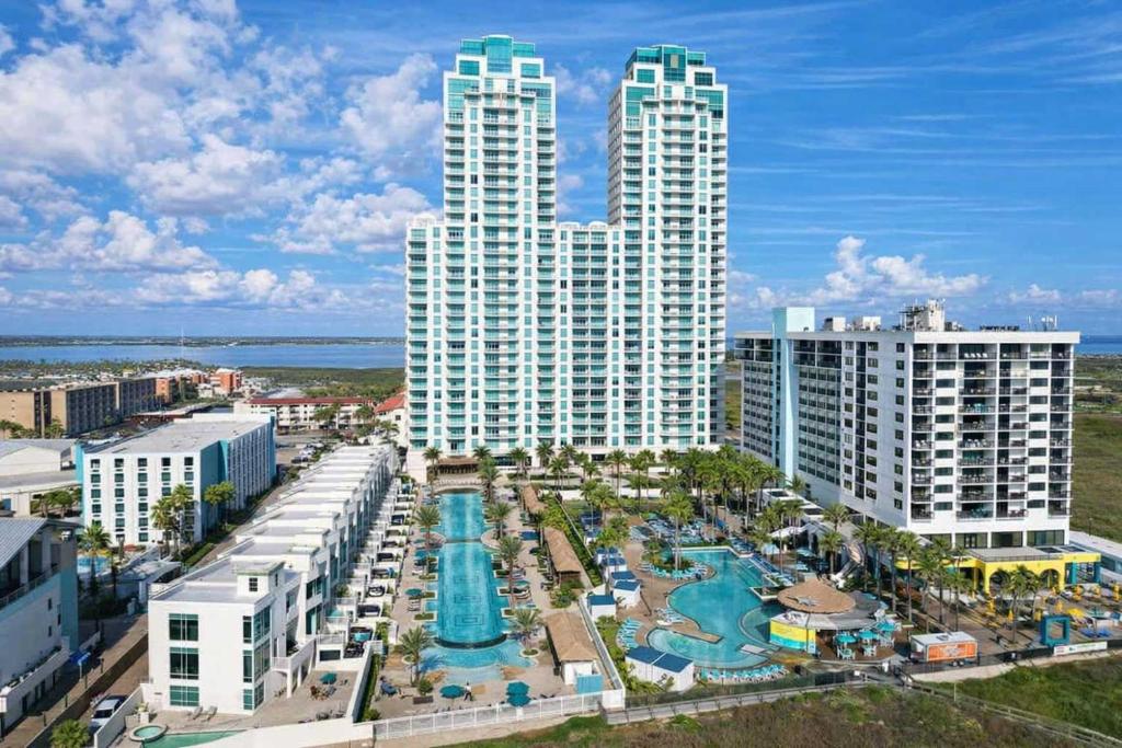 a resort with a pool and two tall buildings at Sapphire 1706 home in South Padre Island