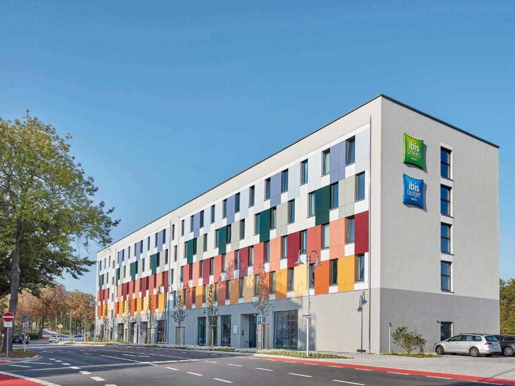 a building with colorful windows on the side of a street at ibis budget Bayreuth in Bayreuth