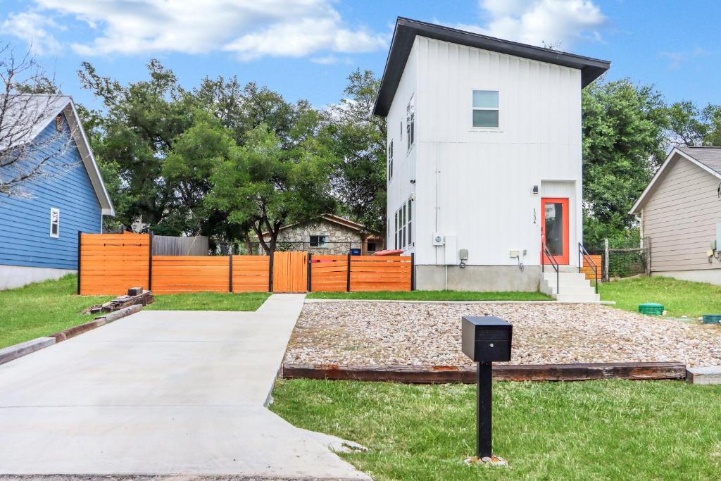 a white house with an orange fence at Pitch Perfect in Canyon Lake