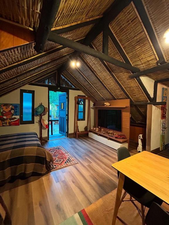 a living room with a bed and a fireplace at Chalé - Refúgio Serra das Águas in Araras Petropolis
