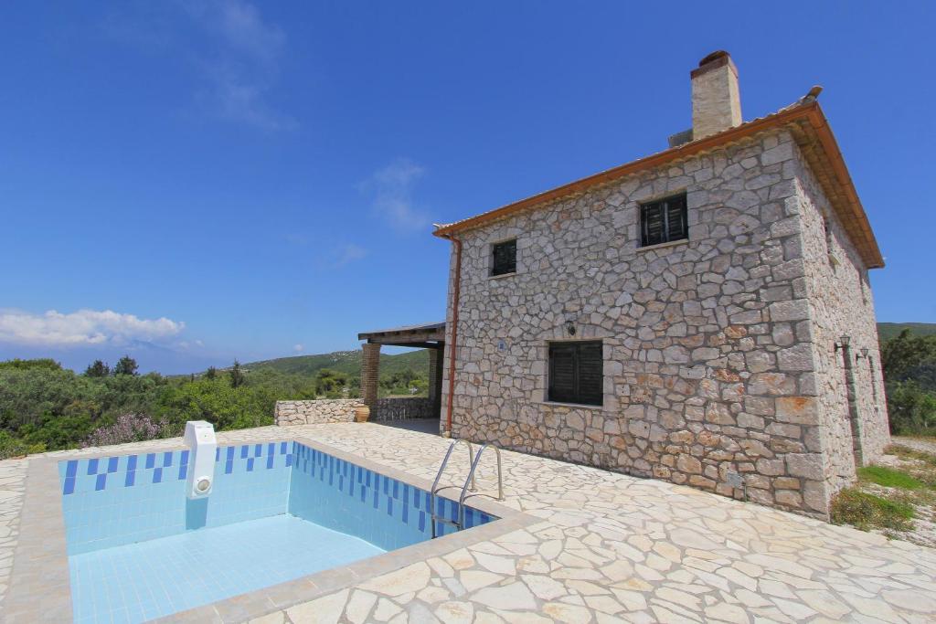 a house with a swimming pool next to a building at Villa Katerina in Chania