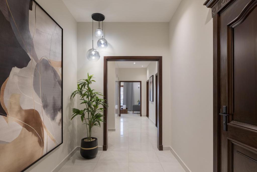 a hallway with a potted plant in the middle at Sleep Inn Apart-Hotel in Cairo