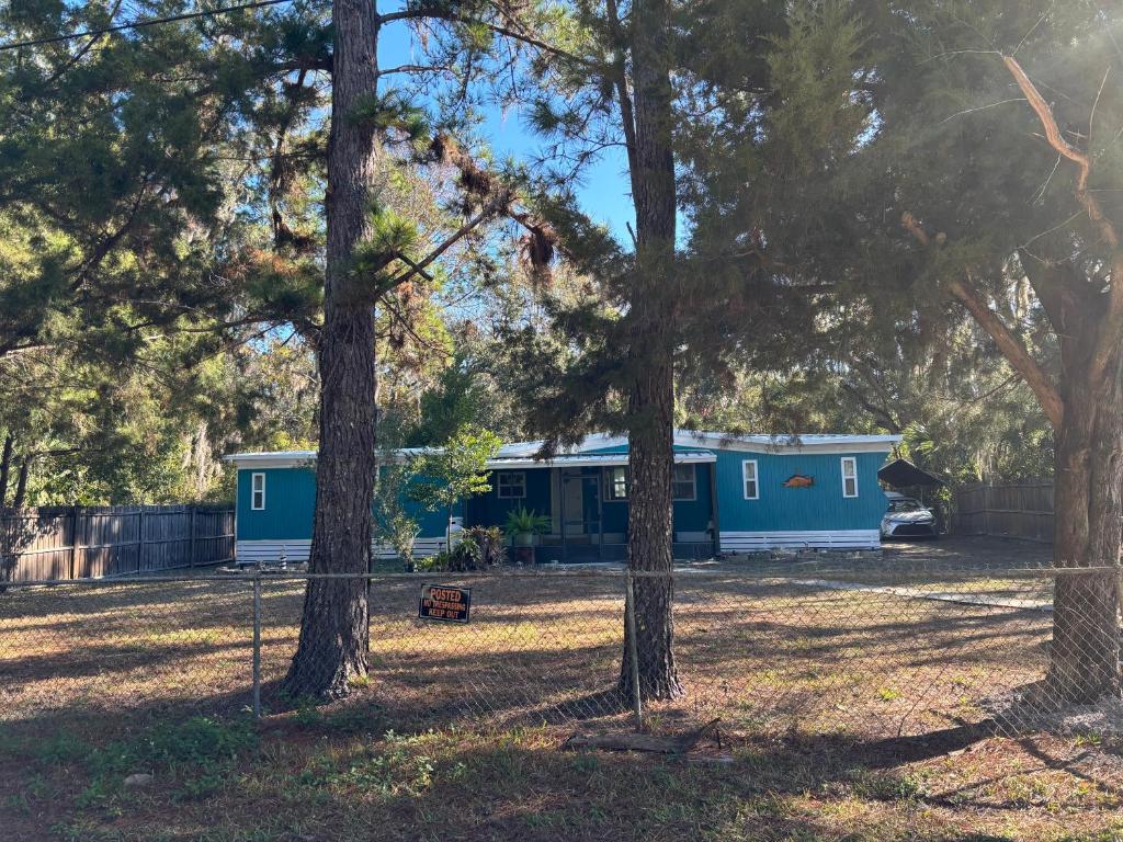 a couple of blue trailers in a field with trees at Prime Crystal River location! in Crystal River