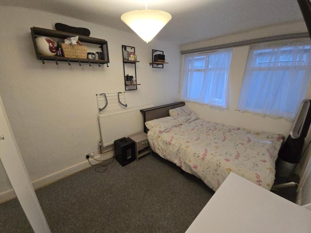 a bedroom with a bed and a television in it at Private Double Room near Bognor Beach! in Bognor Regis