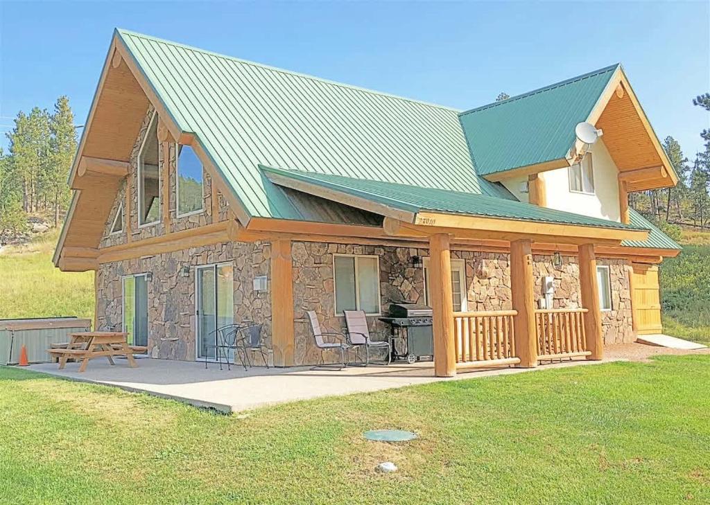 a log cabin with a porch and a deck at Cottage at Storm Mountain #5 in Hill City