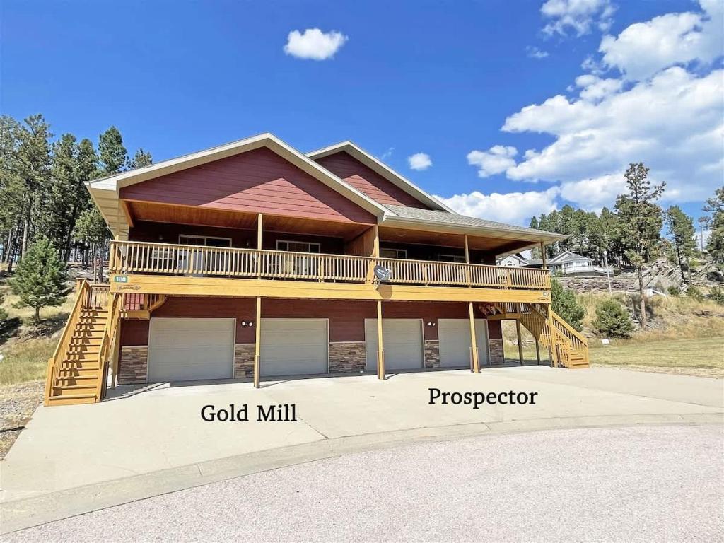 a house with a wrap around deck with the words good mill at Gold Mill in Hill City