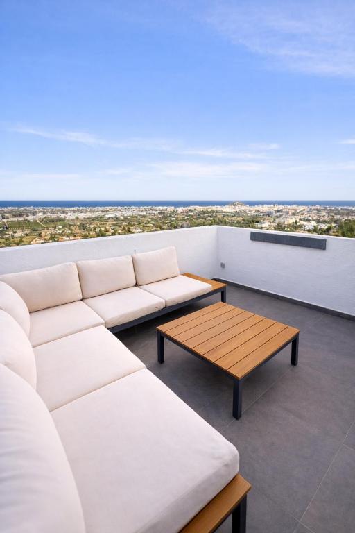 a living room with a white couch and a coffee table at Mediterranean View Apartment in Denia