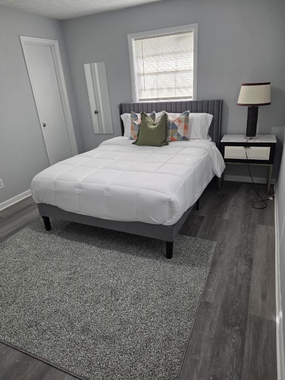 a bedroom with a large white bed with pillows at Private guest rooms & baths in Atlanta