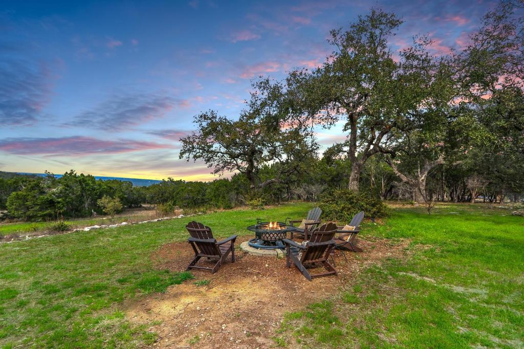 a group of chairs sitting around a table in a field at Casa Robles- The Mockingbird in Wimberley