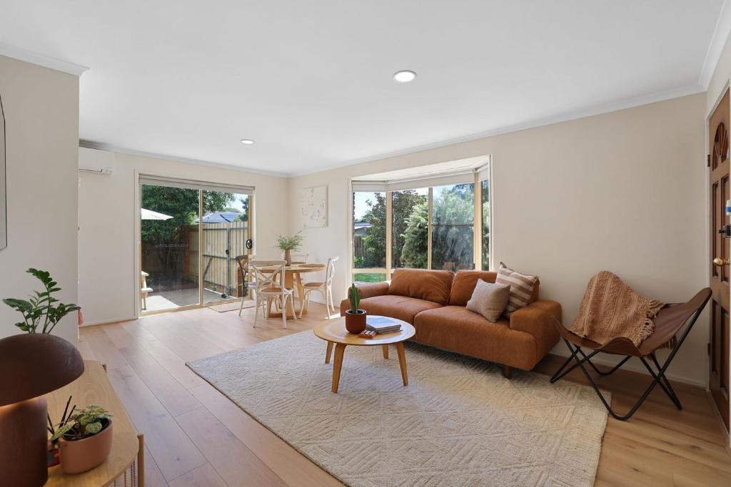 a living room with a couch and a table at Cowes Monash Hideaway in Cowes