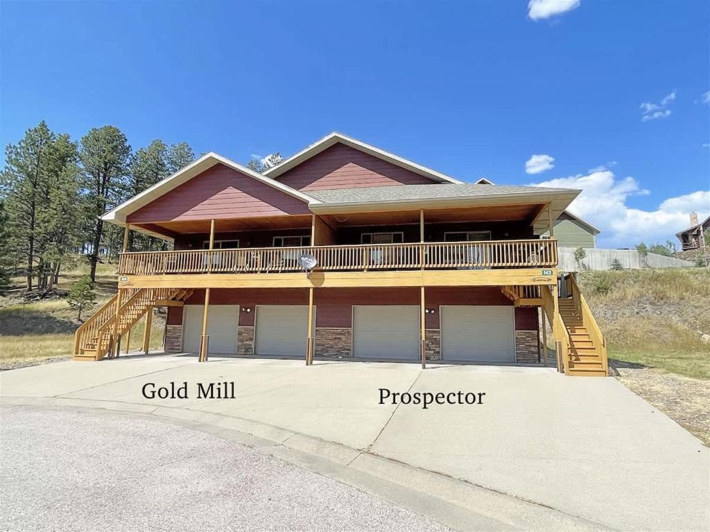 a large house with a deck at Prospector in Hill City