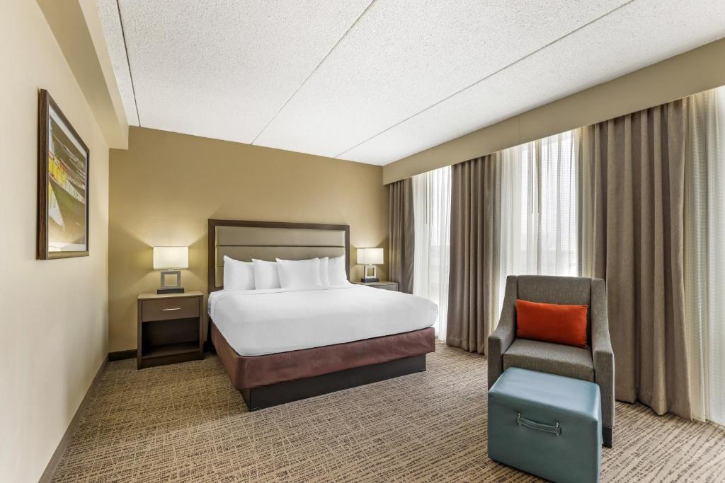 a hotel room with a bed and a chair at Best Western Holiday Lodge in Clear Lake