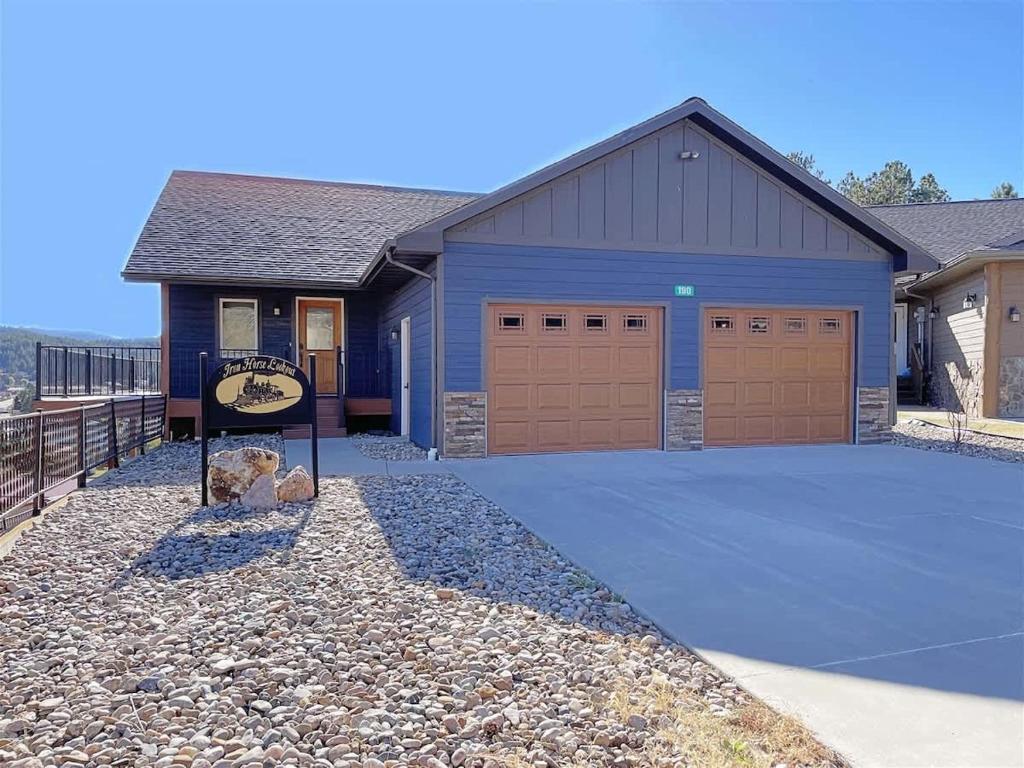 a blue garage with a sign in front of it at Iron Horse Lookout in Hill City