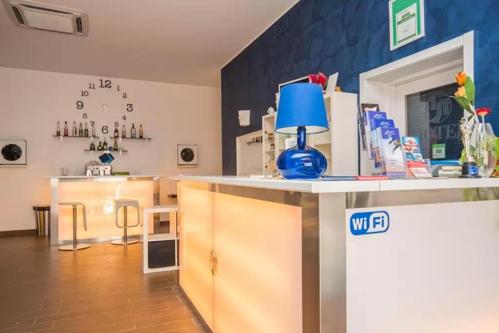 a kitchen with a counter with a blue lamp on it at Hotel Noto Marina Scirocco & SPA in Noto Marina