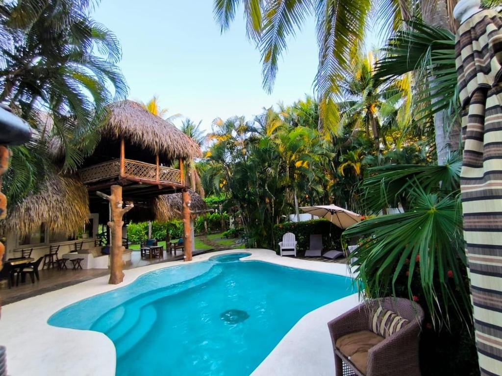 a swimming pool in a resort with a gazebo at Candelaria 5 Moterrico in Taxisco