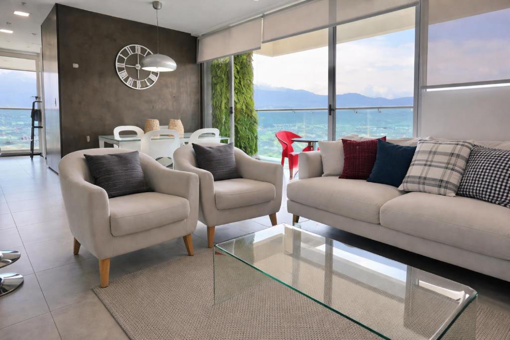 a living room with two couches and a table at Torre Ambar Executive Residences in San José