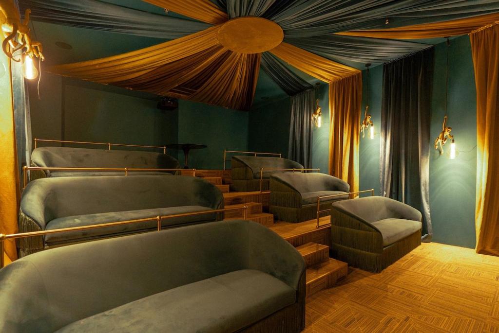 a room with four beds and chairs in it at Secrt Escalante Premium Studio AC in San Pedro
