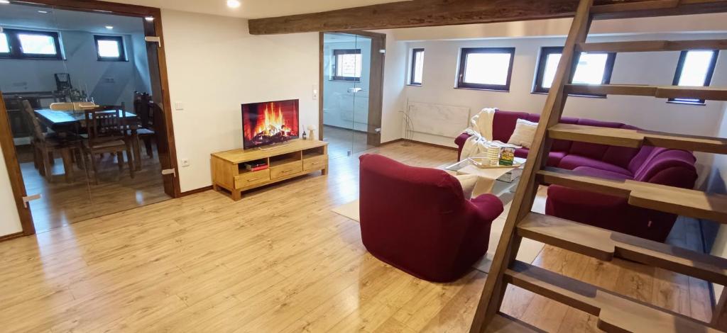a living room with a bunk bed and a living room with a fireplace at Woodlight Loft - Sauna & Nature Escape near Rothenburg ob der Tauber - Self Check-in in Diebach