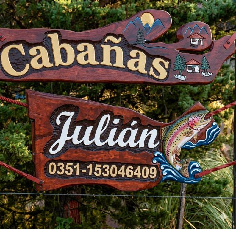 a sign for a restaurant with a fish on it at Cabaña julian in Villa Berna