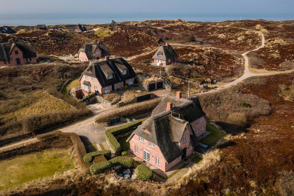 an aerial view of an old house on a hill at Sand Beach in Rantum