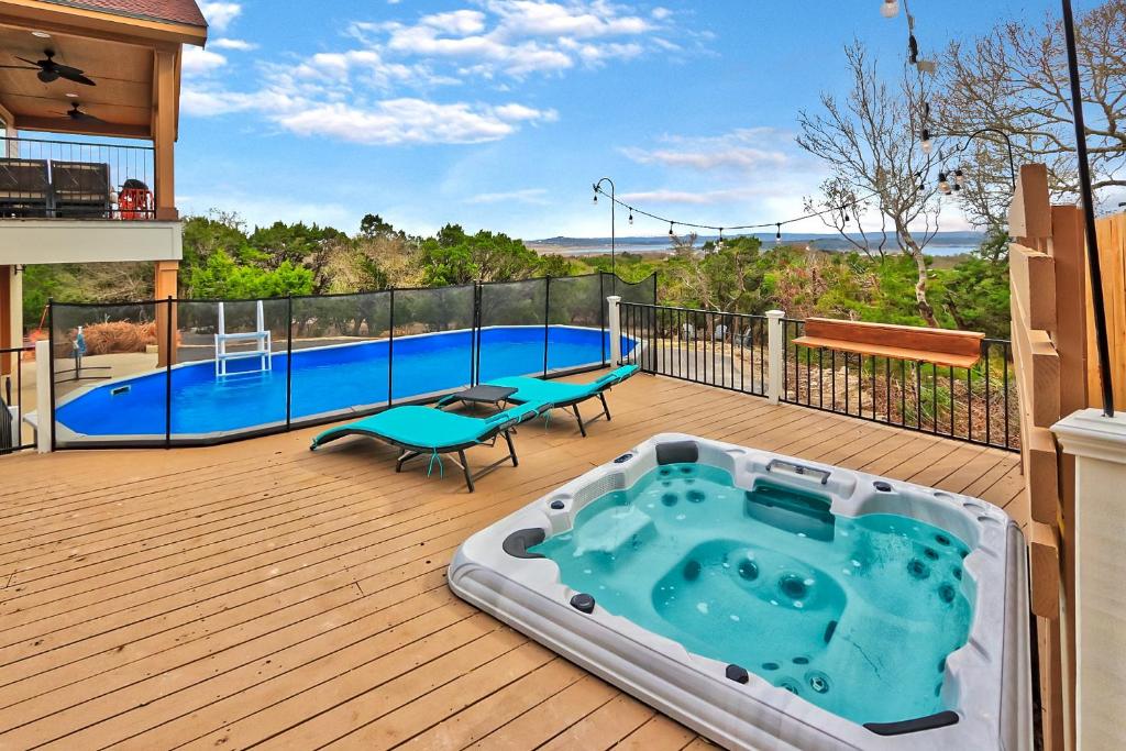 a deck with a pool and a hot tub at Scenic Terrace in Canyon Lake