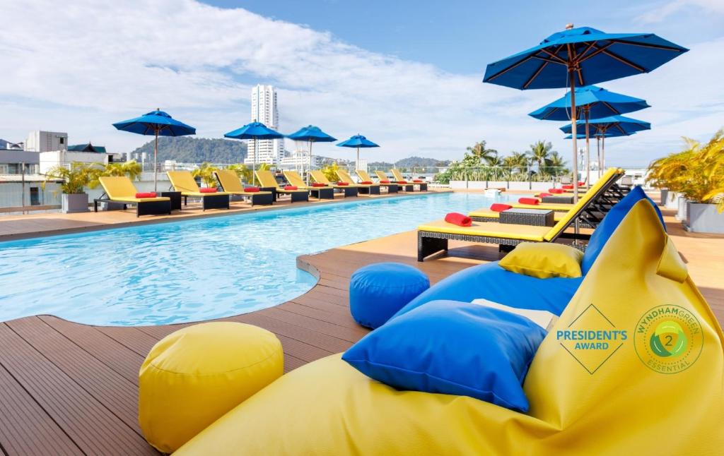 a pool with an inflatable shark pool noodle at a hotel at Days Inn by Wyndham Patong Beach in Patong Beach