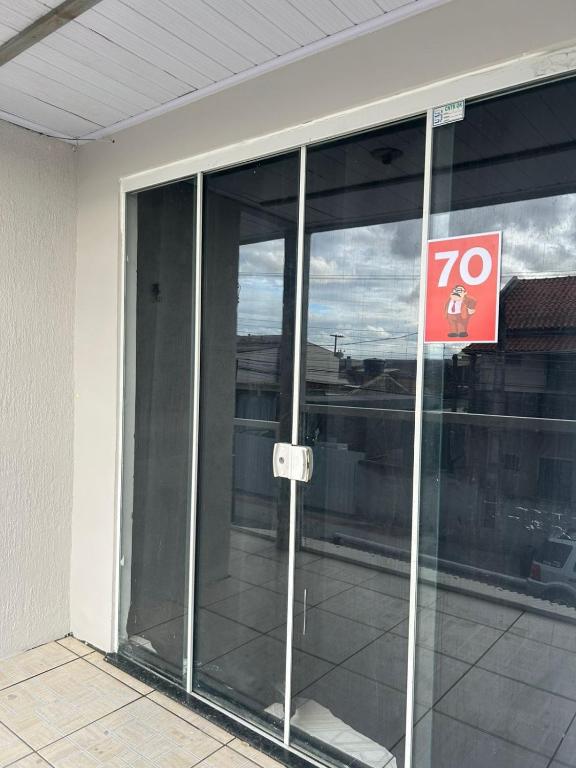 a sign in front of a glass building at Vila do Chaves Sr Barriga 70 in Itajaí