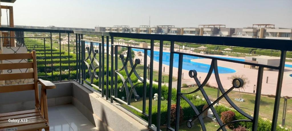 a balcony with a view of a swimming pool at chalet - Plumar El Sokhna in Ain Sokhna