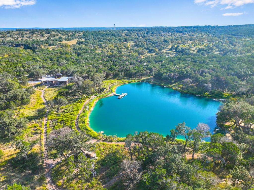 an aerial view of a lake in the woods at Wild Candy-Plum Wild in Wimberley