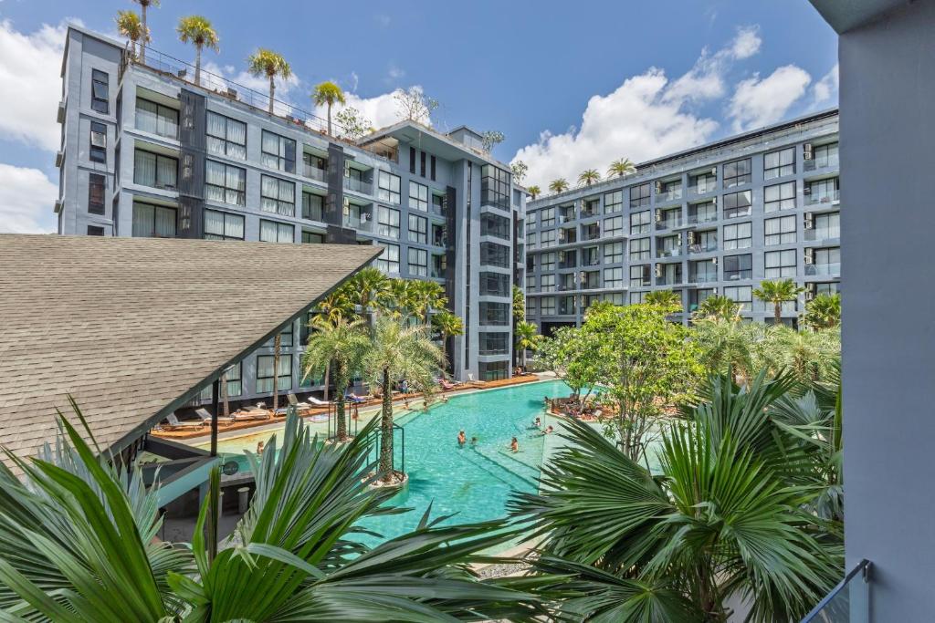 an overhead view of a swimming pool with buildings at 2BR Family Condo with a Pool View - CTG P205 in Kamala Beach