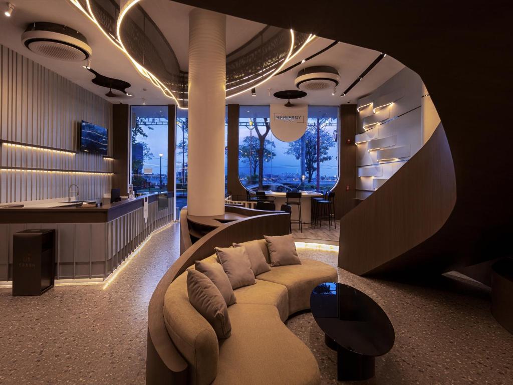 a living room with a couch and a bar at SEENERGY STAY Riverside in Phnom Penh