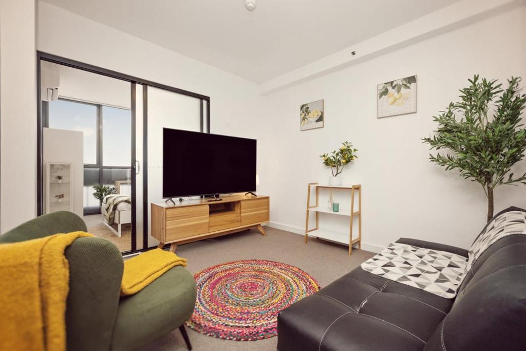 a living room with a tv and a couch at Two Bedroom Unit in Central Adelaide in Adelaide