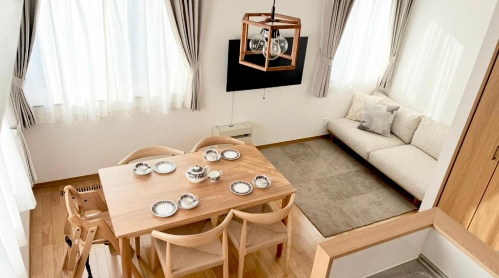 a small living room with a table and a couch at Sa one ko Matsumoto Entire house Free parking 2cars in Matsumoto