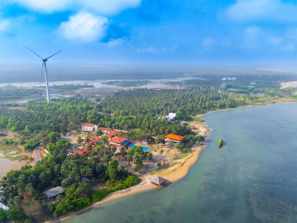 an island with a wind turbine in the water at Saachi Lagoon Resort in Kalpitiya