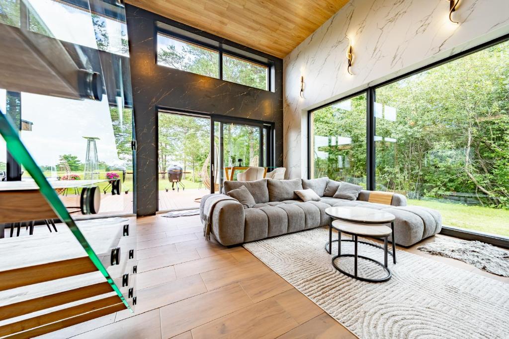 a living room with a couch and a table at Green Field Villa in Kuressaare