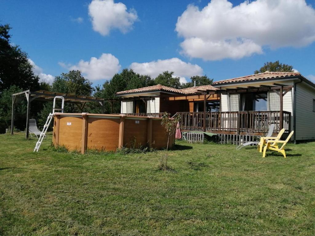 a house with a deck and a playground at Les bichous in Saint-Thomas